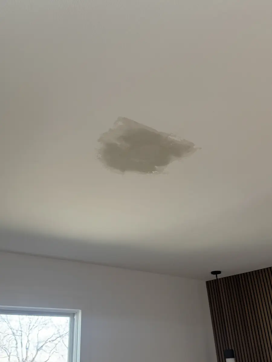Ceiling drywall patch and repair blended into the existing ceiling before finishing
