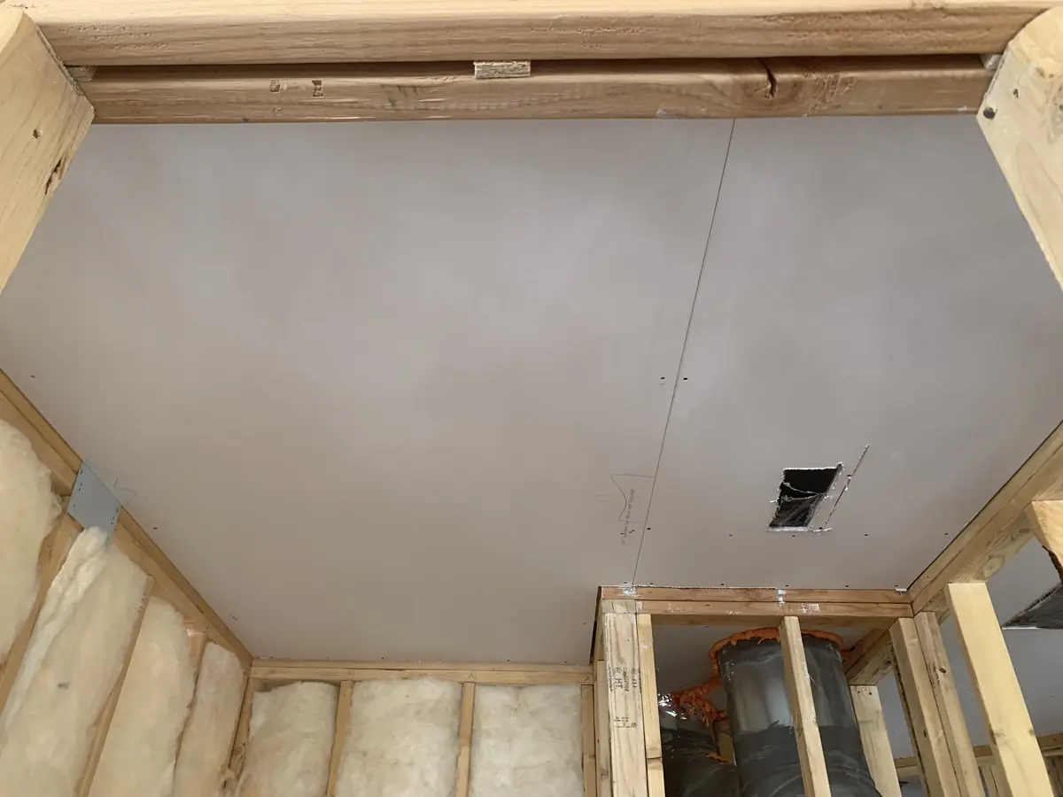 Freshly hung drywall ceiling before taping and mudding on a Denver metro job site