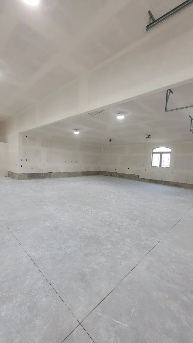 Interior of a large finished garage with drywalled walls and ceiling