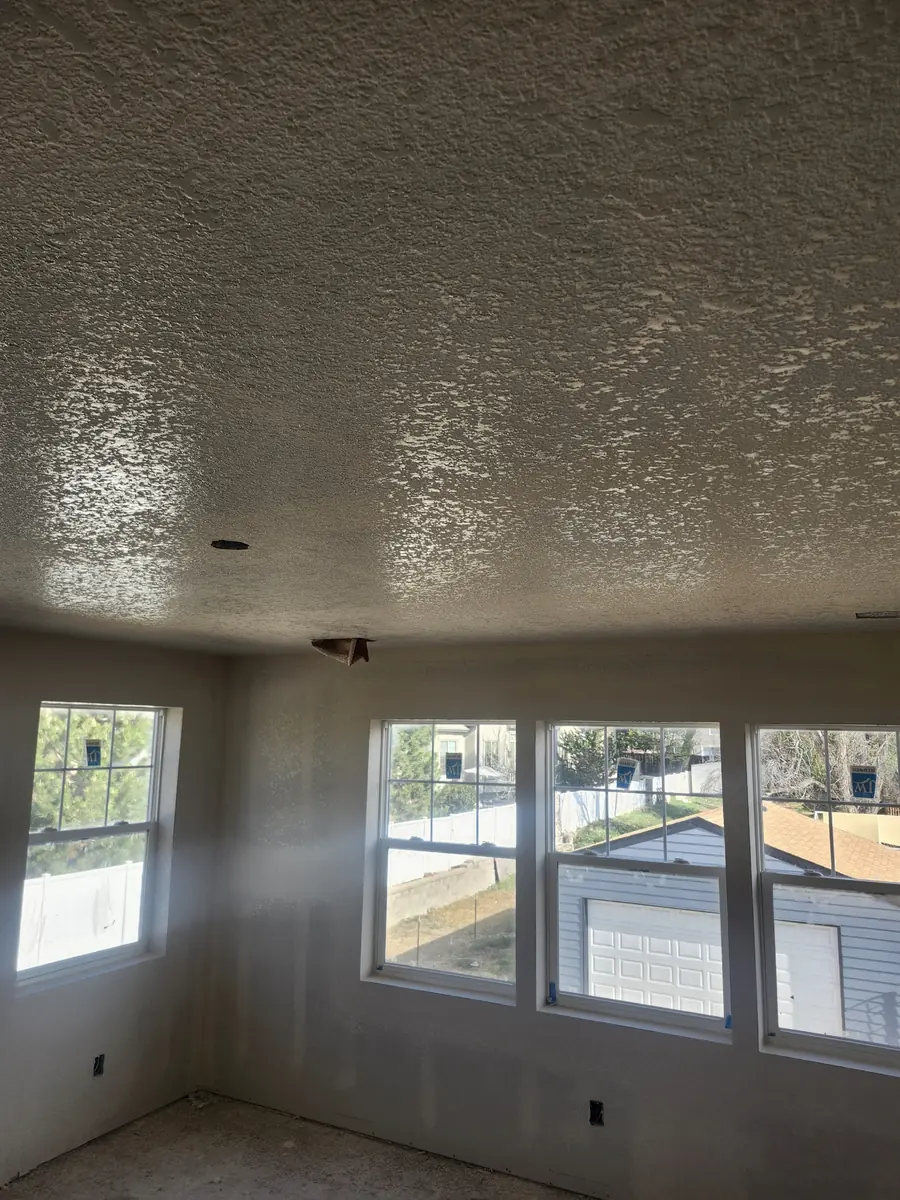 Close-up of a textured drywall ceiling above a Level 4 finished room