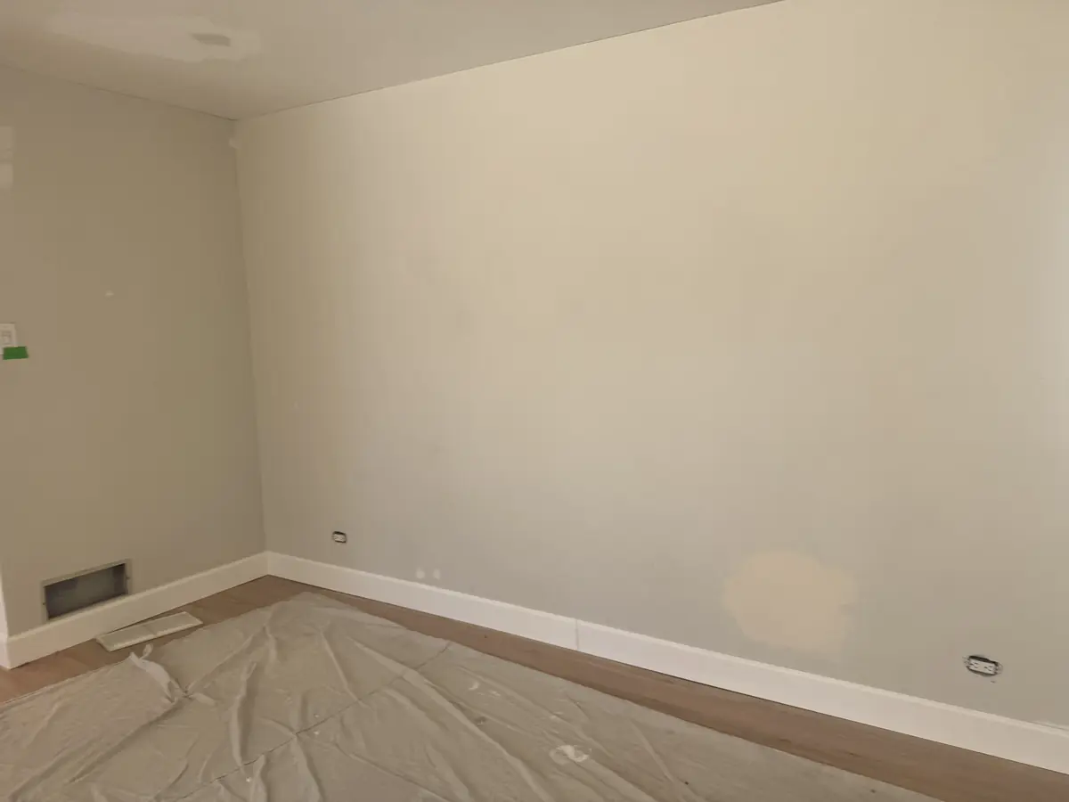 Finished wall and ceiling after drywall patching, taping, and paint-ready finishing